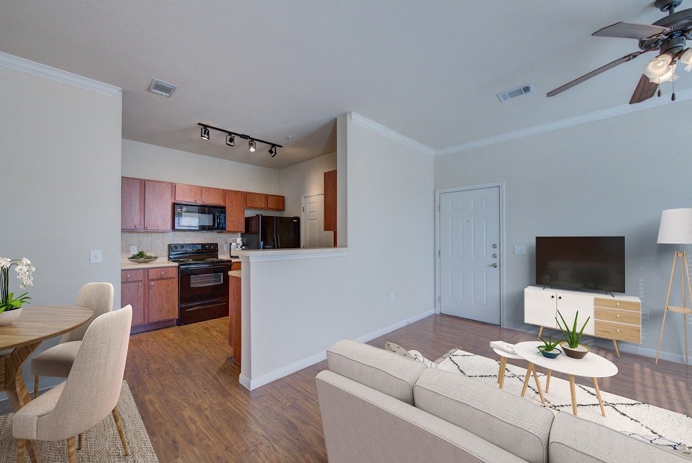 a living room and kitchen with a couch and a table