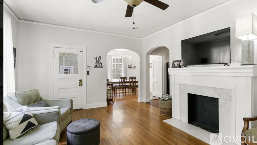 A living room with a fireplace and a television.