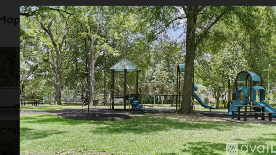 A playground with a blue slide and a green canopy.