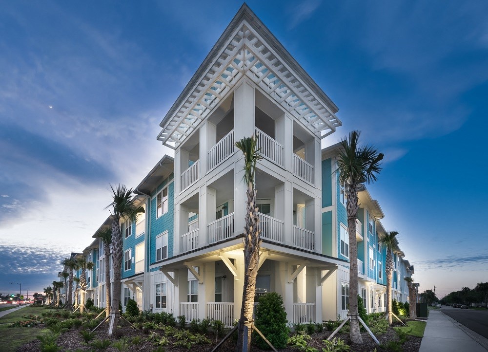 a building with palm trees in front of it