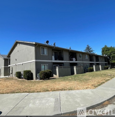 Apartment complex with a clear blue sky above.