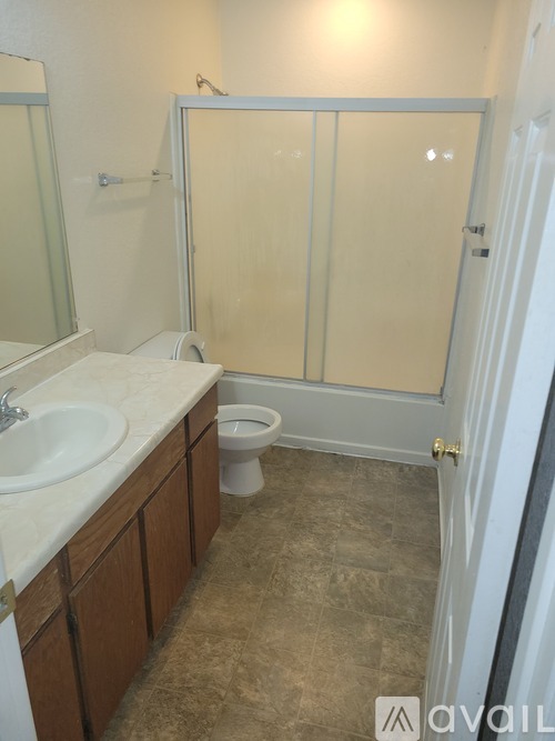 A bathroom with a sink, toilet and shower.
