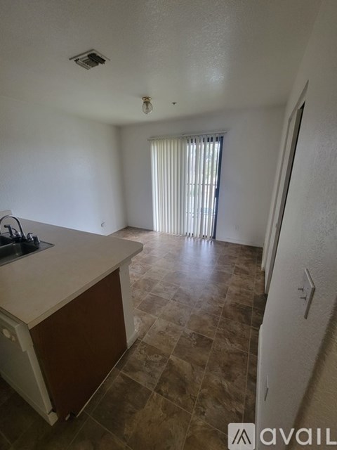 A kitchen with a white counter top and brown cabinets.