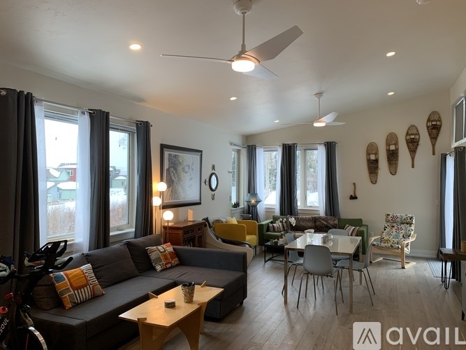 A living room with a grey couch and a wooden coffee table.