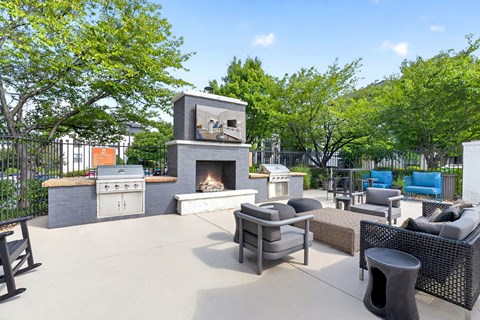 A patio with a fireplace and seating area.