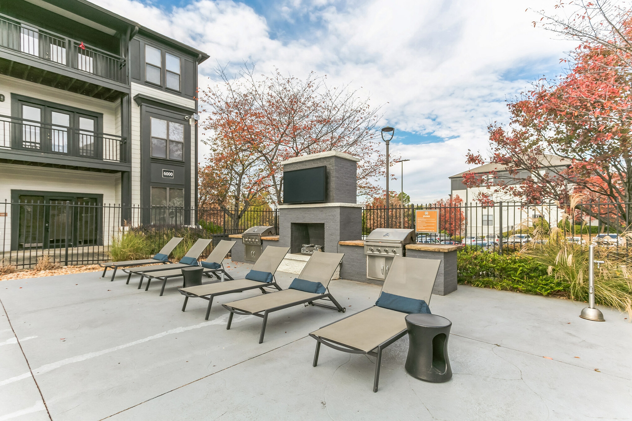 an outdoor patio with lounge chairs and a fire pit