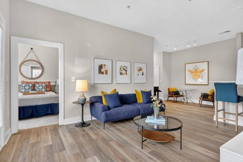 A living room with a blue couch and a coffee table.
