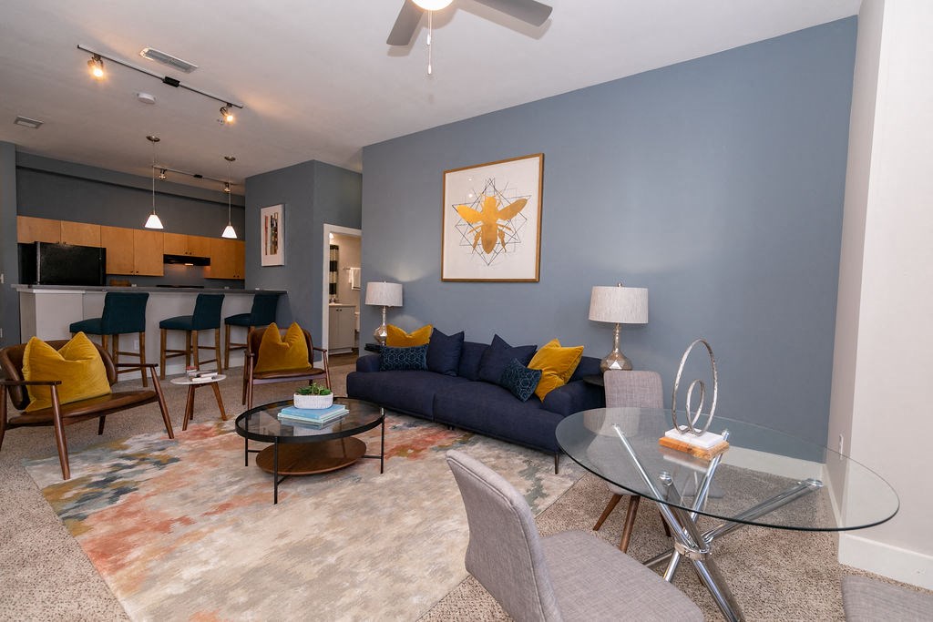 a living room with a couch and a glass table