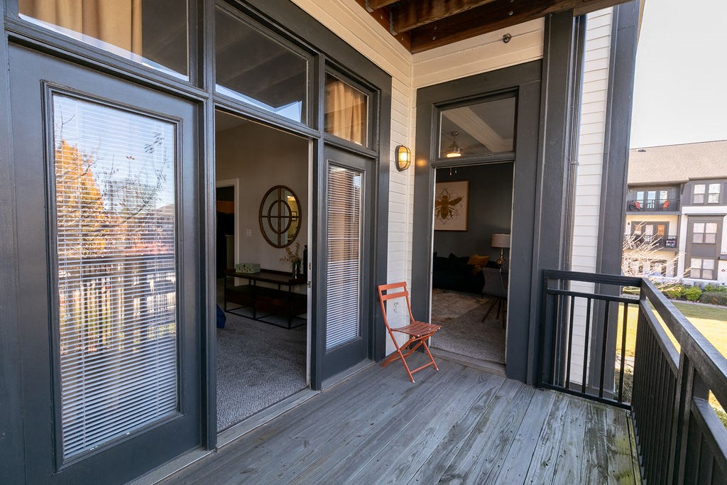 a balcony with a chair and some windows