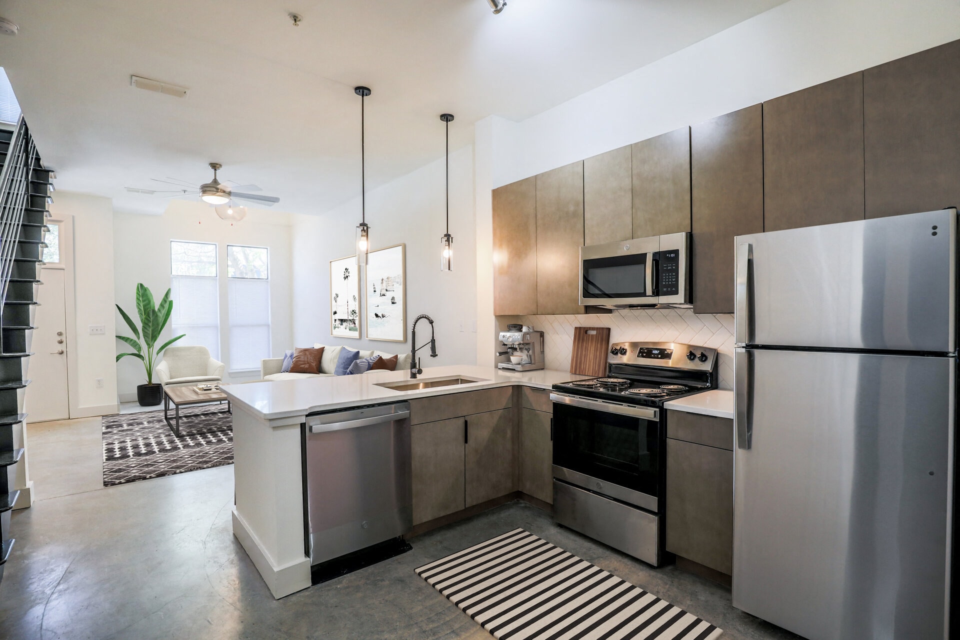 a kitchen with stainless steel appliances and a white counter top