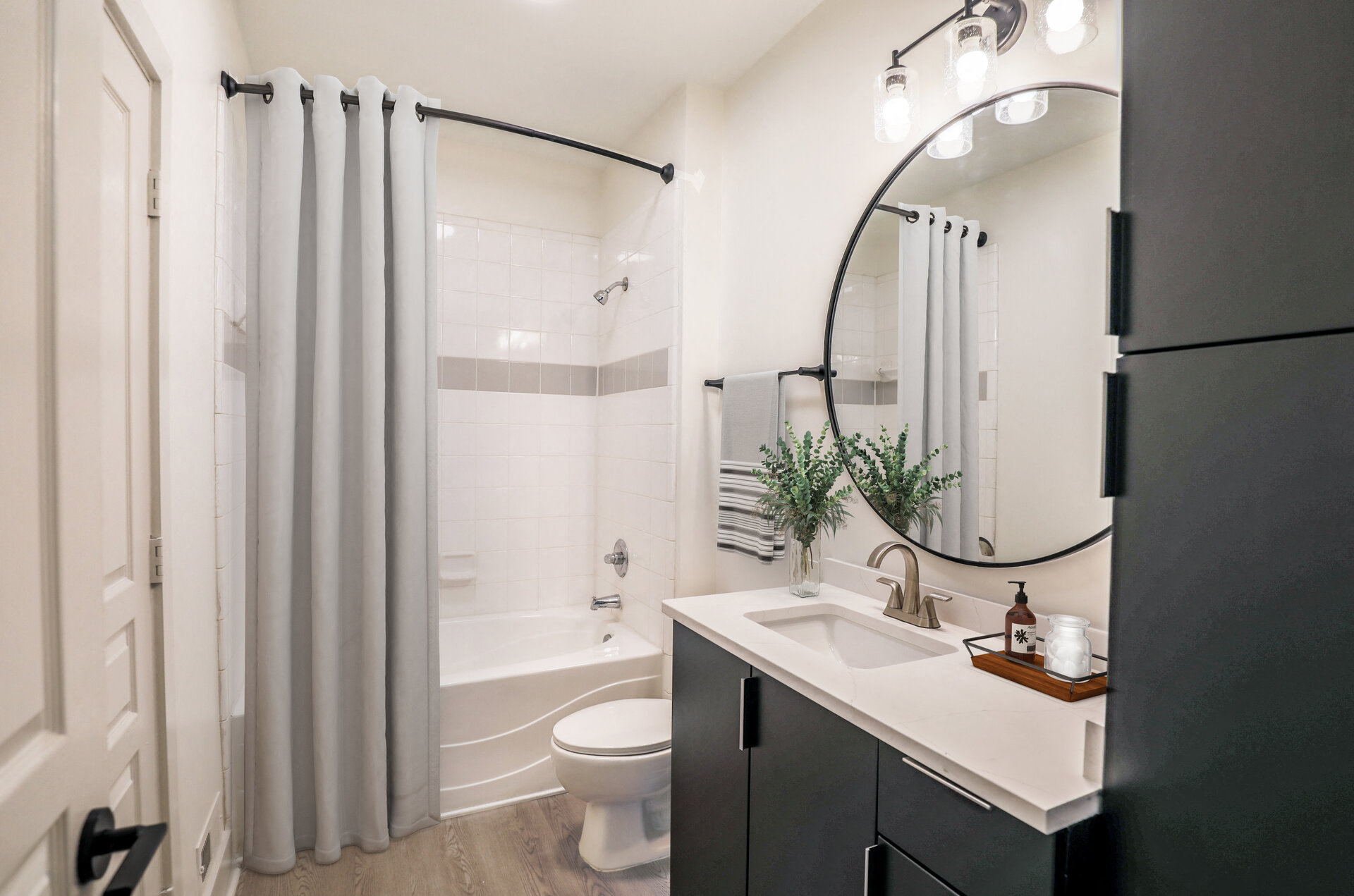 a bathroom with a shower and a sink and a toilet