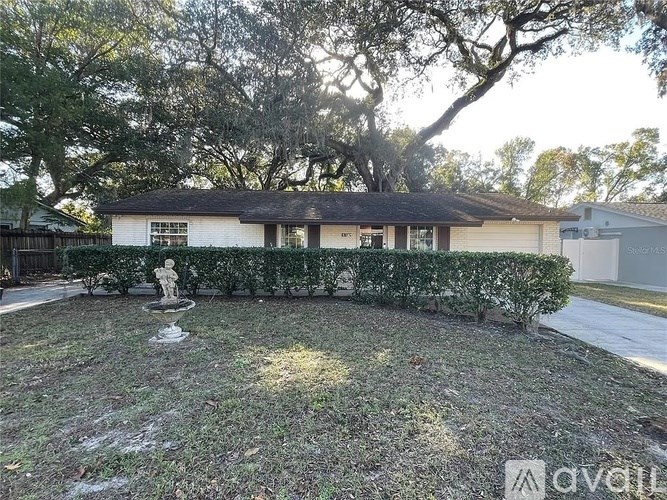 A white house with a statue in front of it.