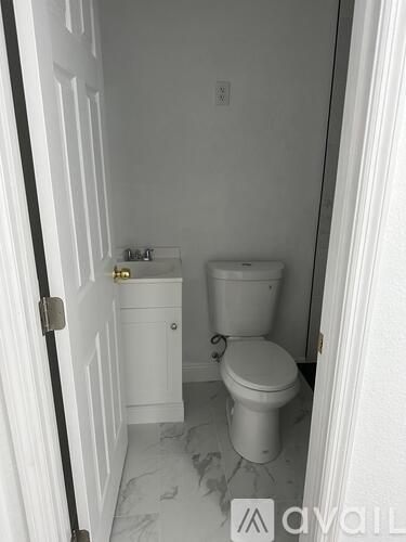 A room with a brown door and wooden floor.