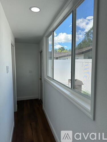 A room with wooden floors and a ceiling fan.