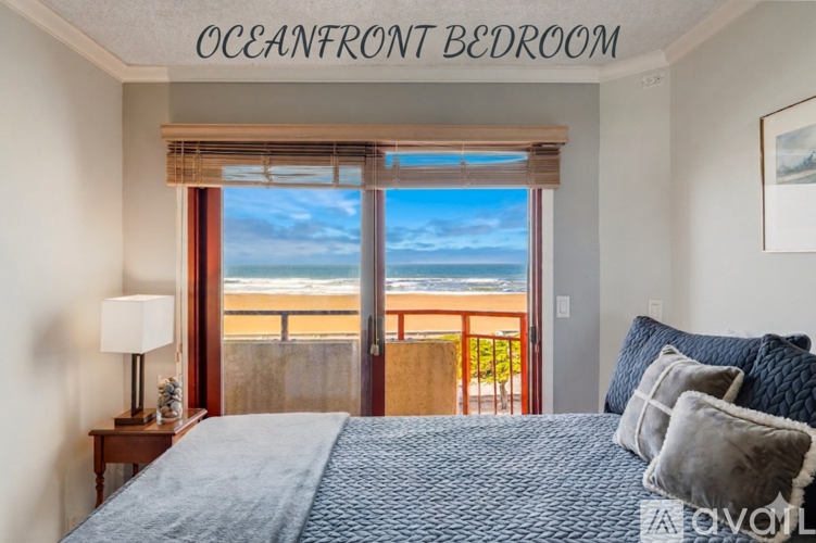 A bedroom with a large bed and a view of the beach.