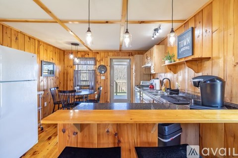 A kitchen with wooden cabinets and a black stove top.