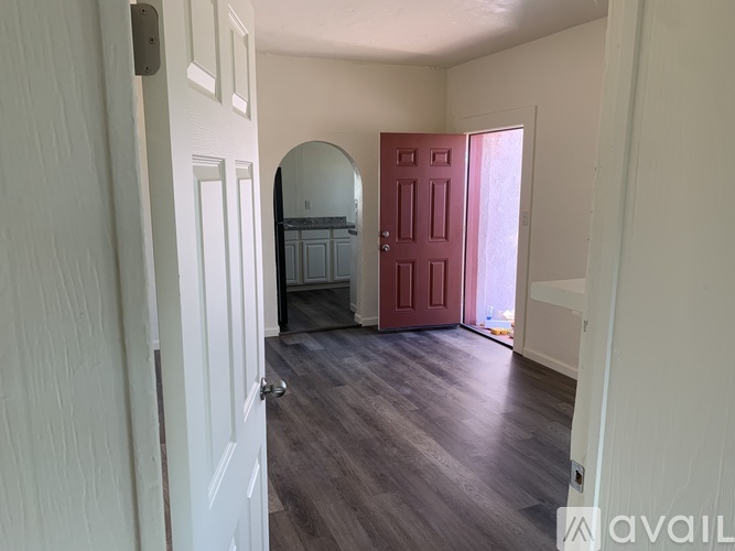 A room with a red door and a white door.