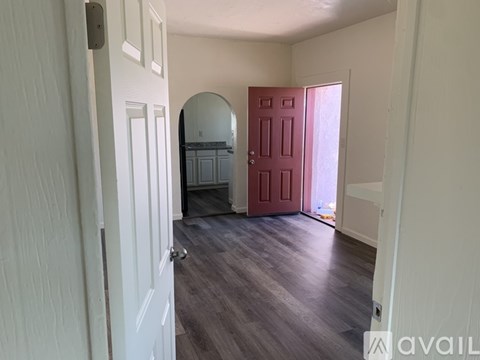 A room with a red door and a white door.