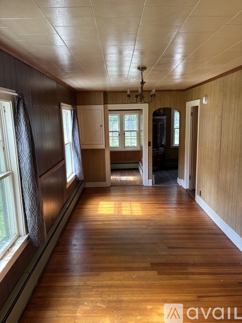 A room with wooden floors and a white door.
