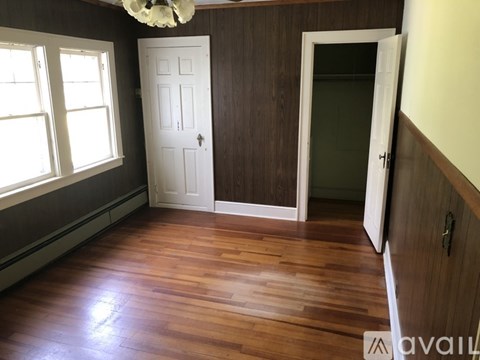 A room with wooden floors and a white door.