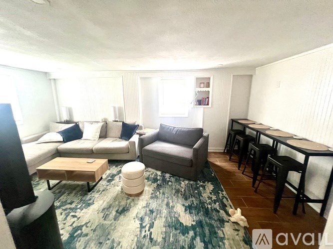 A living room with a couch, armchair, and coffee table.