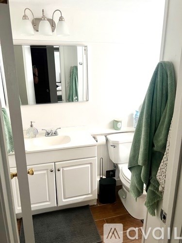 A bathroom with a white sink and a white toilet.