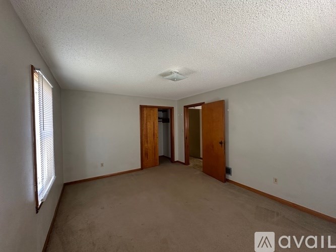 A room with two doors and a window.