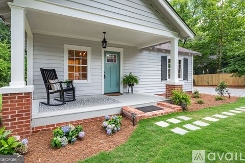 A house with a porch and a blue door.