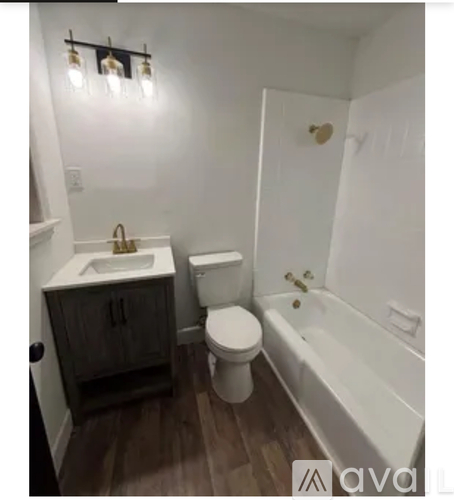 A bathroom with a toilet, sink, and bathtub.