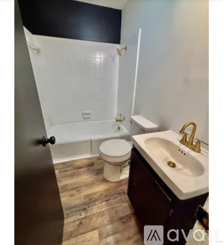 A bathroom with a toilet, sink, and shower.