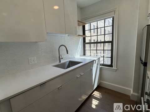 A kitchen with a sink and a window.