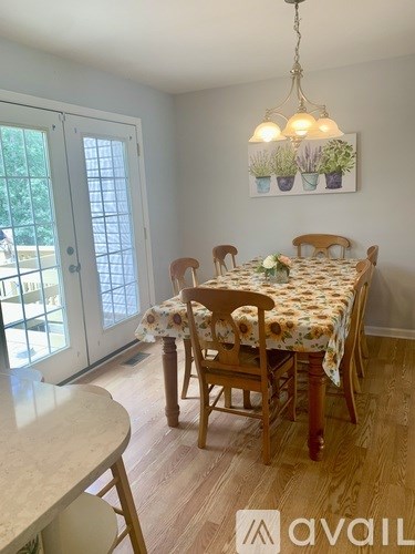 A dining room with a table set for four.