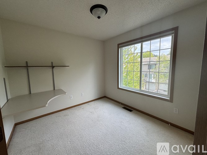 A room with a window and a shelf is available for rent.