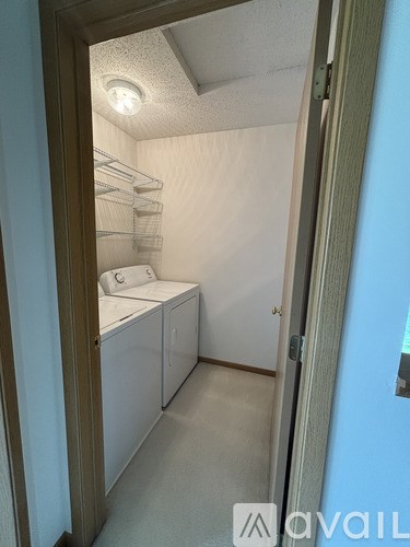 A small laundry room with a washer and dryer.