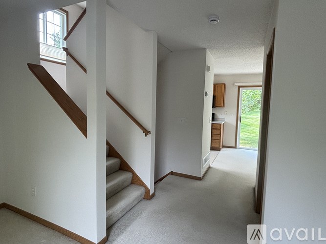 A staircase with wooden handrails leads up to a second floor.