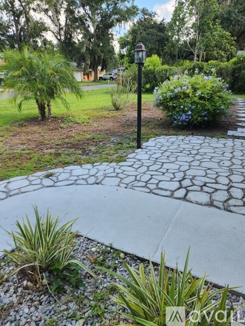 A stone pathway leads through a garden.