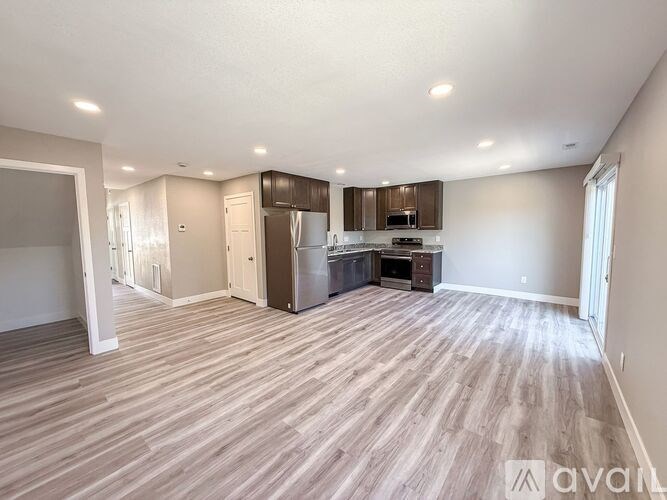 A modern kitchen with a dining table and chairs.