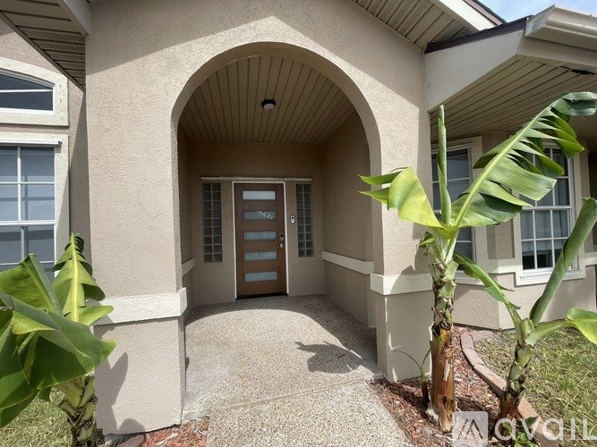 A house entrance with a brown door and a brown archway.