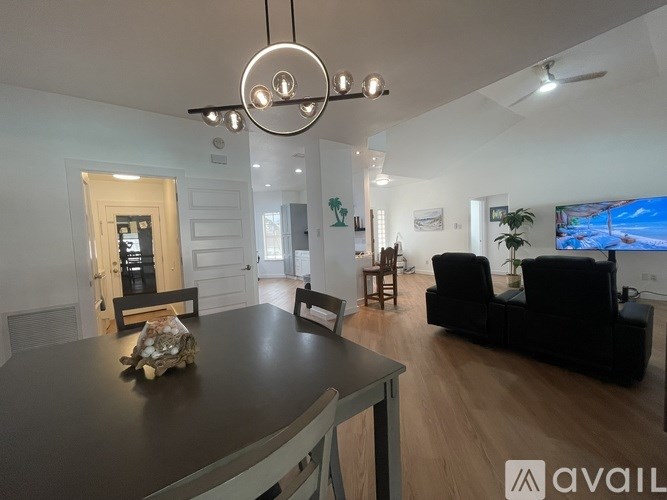 A modern living room with a black table and a television.