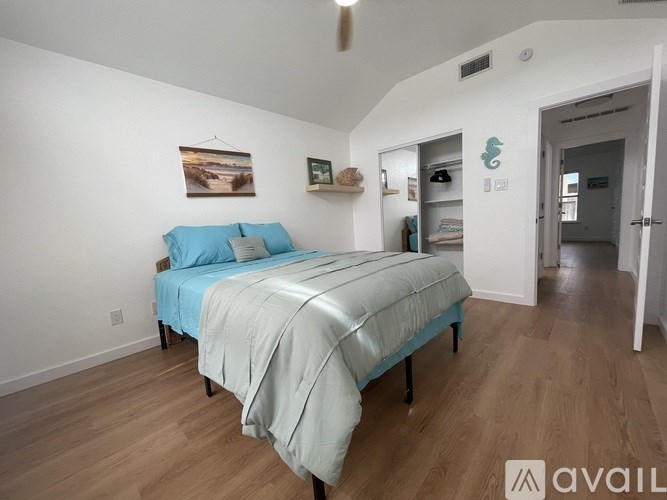 A bedroom with a bed and a painting on the wall.
