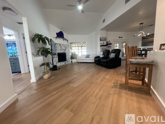 A living room with a fireplace and a wooden chair.