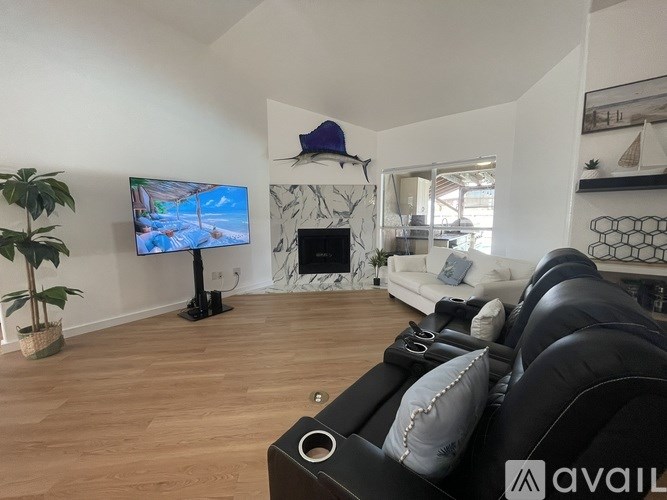 A living room with a TV, a fireplace, and a couch.
