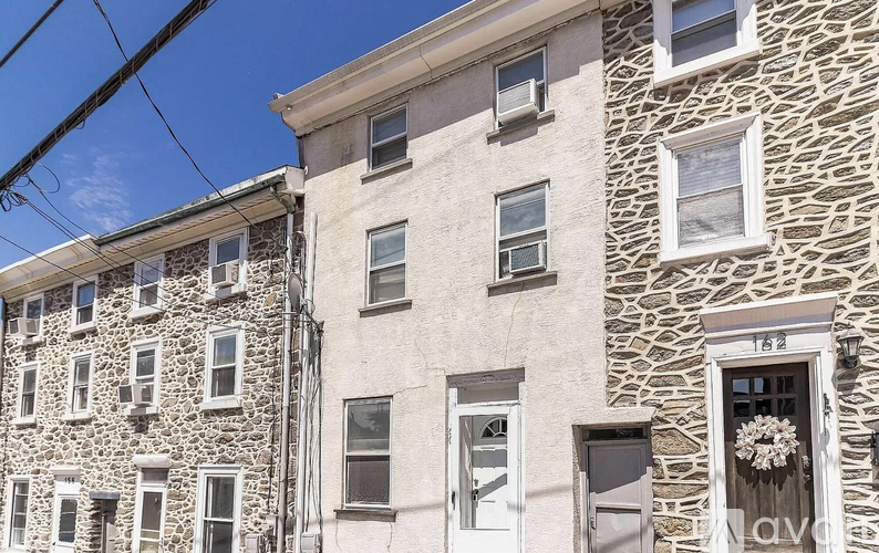A stone building with a sign that says "LAV" on the front door.