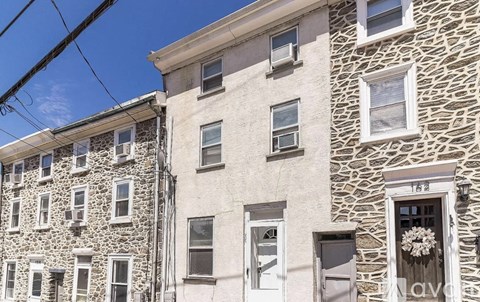 A stone building with a sign that says "LAV" on the front door.