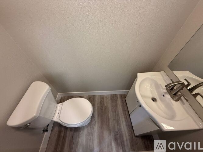 A kitchen with white cabinets and a dining table set for two.
