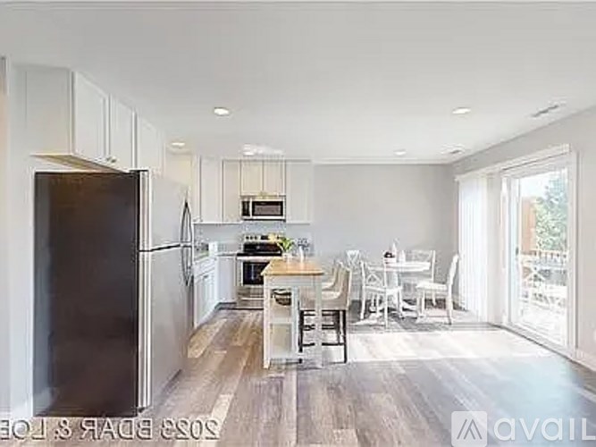 A modern kitchen with a dining table and chairs.