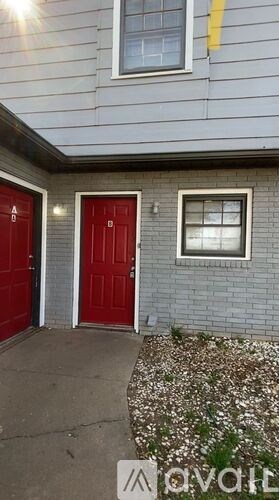 A house with a red door and a window.