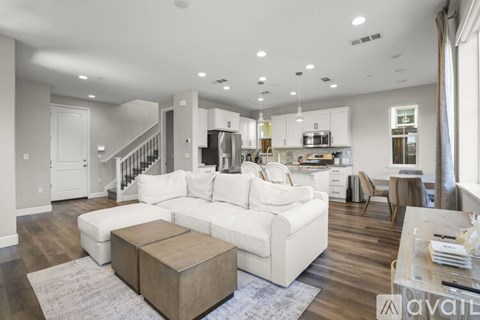 A modern living room with a white sofa and wooden coffee table.