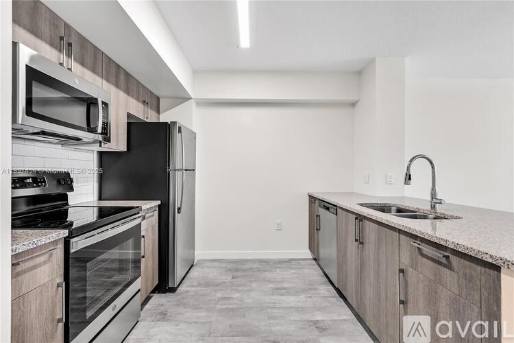 A kitchen with a black refrigerator, stove, and oven.