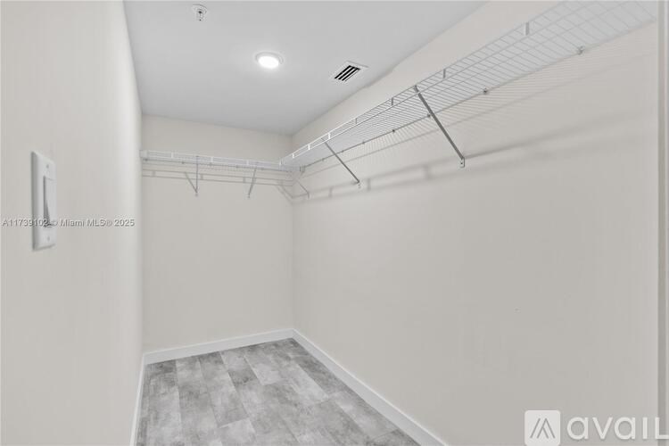 A white wall with a metal rack on it.